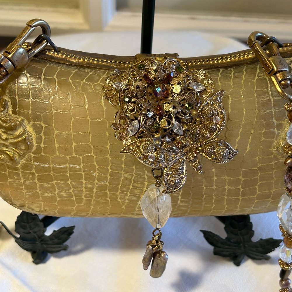 Embellished gold evening bag by Maya